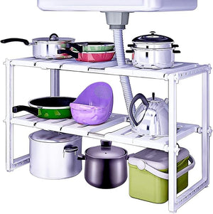 Kitchen shelf with pots, pans, and bowls underneath a sink