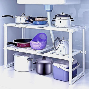 Kitchen shelf with pots, pans, and bowls on a white background
