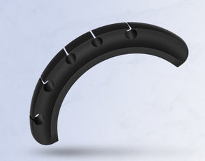 Black curved object with multiple holes on a light gray background